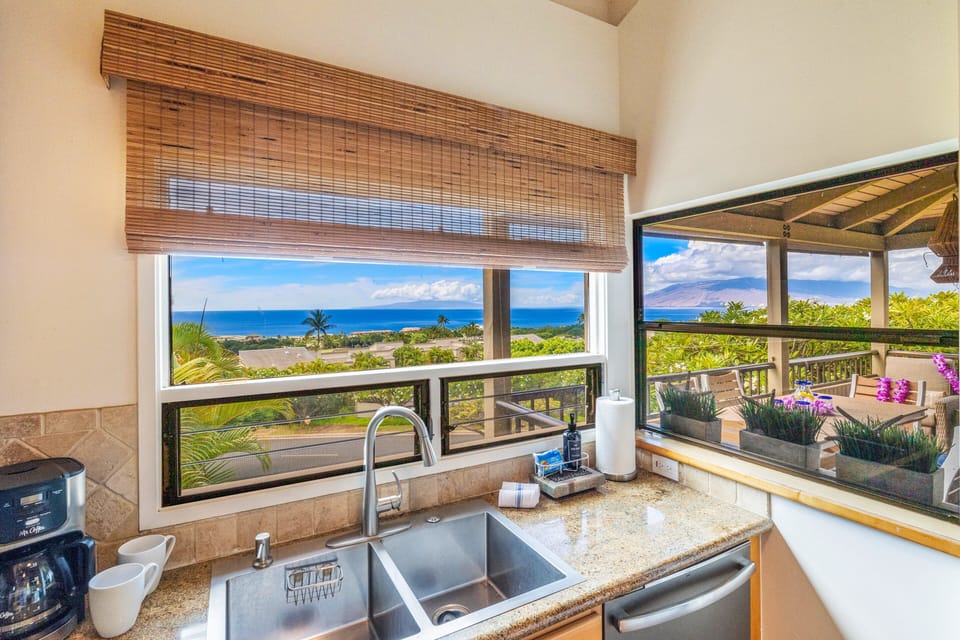 Sinks gleam beneath bamboo shades, patios and sea stretching beyond the glass.