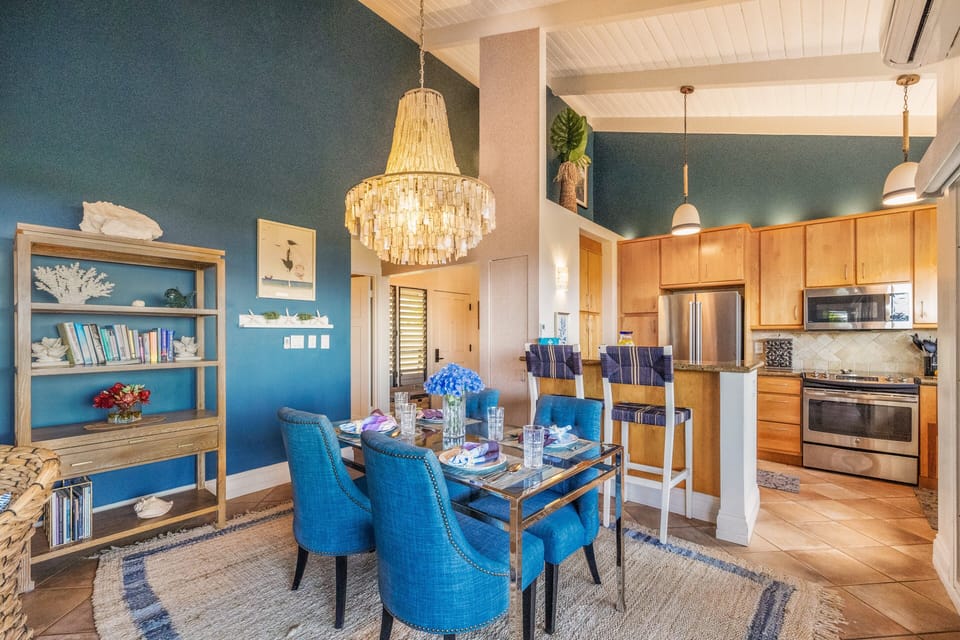 Kitchens connect with wood and steel, bookshelves and accents tying the design together.