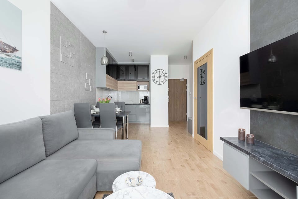 A bright living room with a comfortable sofa and a television for evening entertainment. 