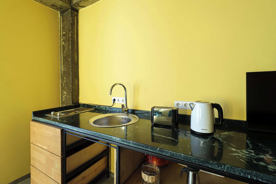 Kitchenette with sink toaster kettle a small electric stove