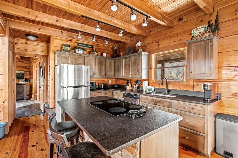 Rustic charm meets modern convenience in this fully stocked kitchen, complete with stainless appliances, mountain-inspired décor, and plenty of space to cook, sip, and gather.