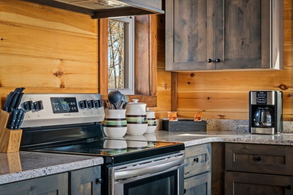 Start your morning in this cozy corner of the kitchen—coffee brewing, sunlight streaming through the trees, and everything you need within arm’s reach to prep for a day in the mountains.