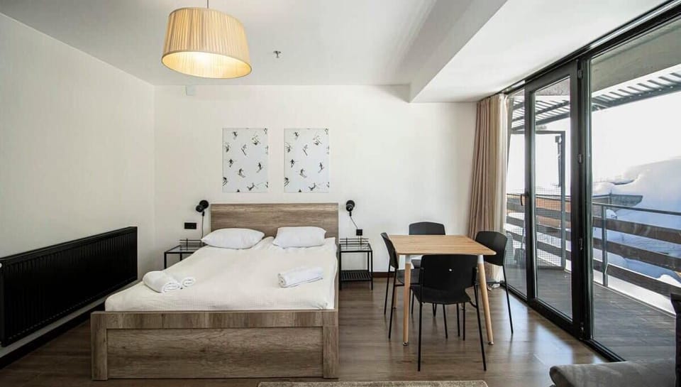 This space feels fresh and modern, with crisp linens on a comfy bed.