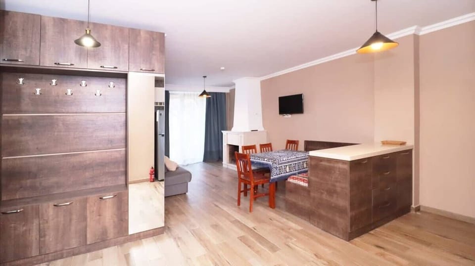 With ample space and a warm fireplace, the living room is ideal for group activities like dining, game nights, or simply unwinding in comfort.