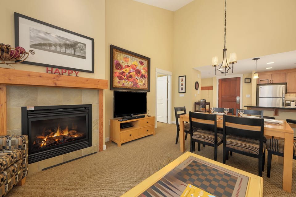 Cozy up by your crackling fireplace while enjoying meals at your dining table, with a full kitchen ready for your culinary adventures.