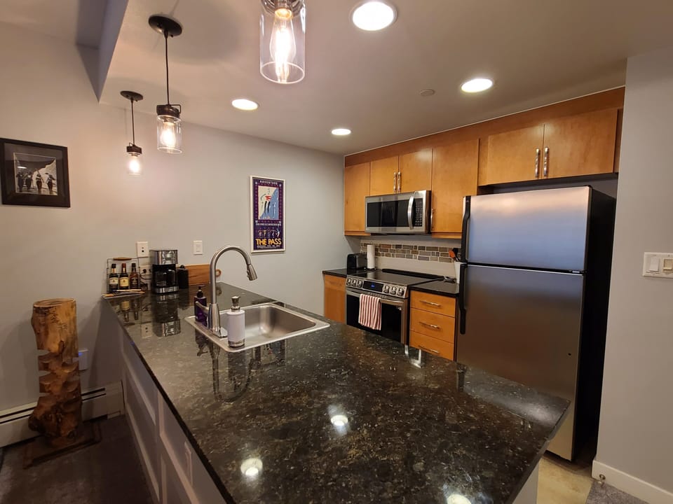 Your modern kitchen awaits with gleaming granite counters, stainless appliances, and stylish pendant lighting for memorable home-cooked meals.