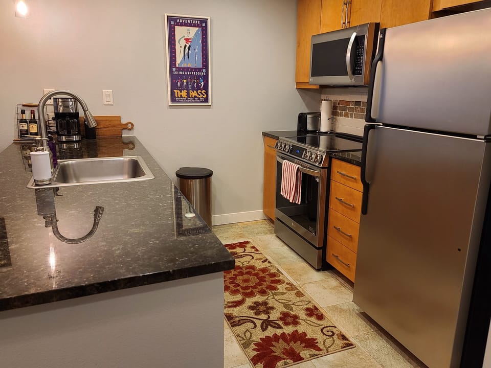 Your fully equipped kitchen awaits with sleek granite counters, stainless steel appliances, and everything needed to create memorable meals during your stay.