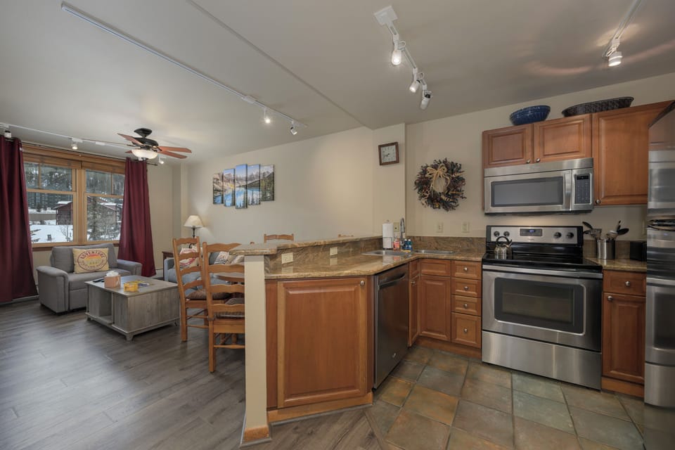 Your fully equipped kitchen flows seamlessly into a cozy living area, creating the perfect space for cooking meals and relaxing together.