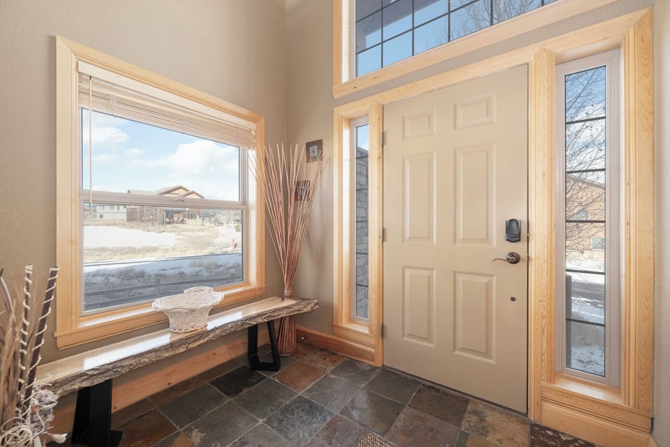 Step into your bright entryway with stunning natural light and a welcoming bench to sit while you prepare for mountain adventures.