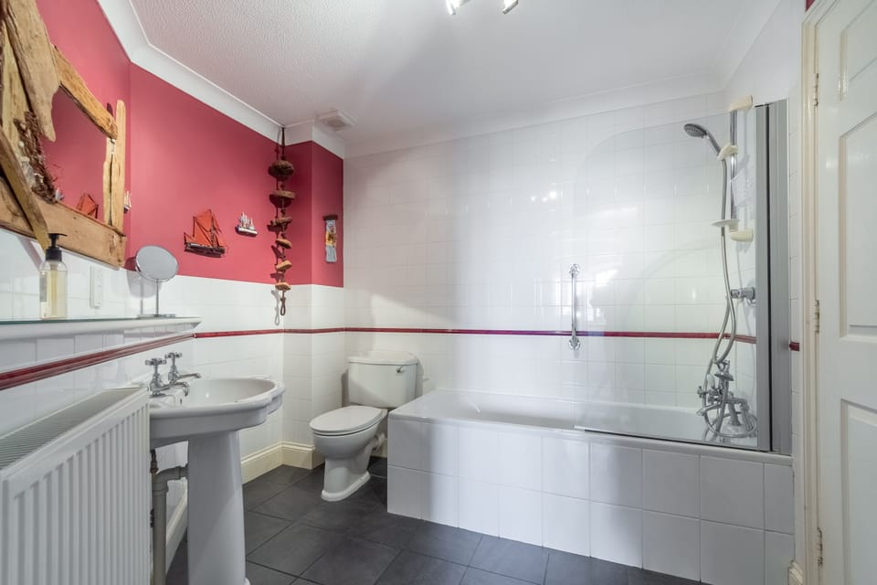 First floor: The bathroom has bath with shower over