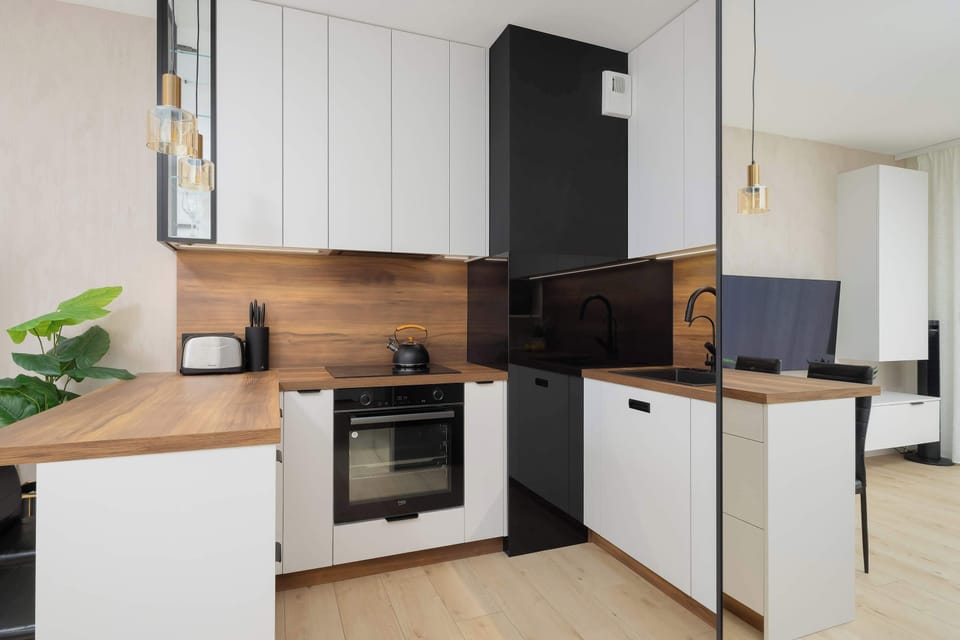 The sleek design of the kitchenette blending seamlessly with the living area.
