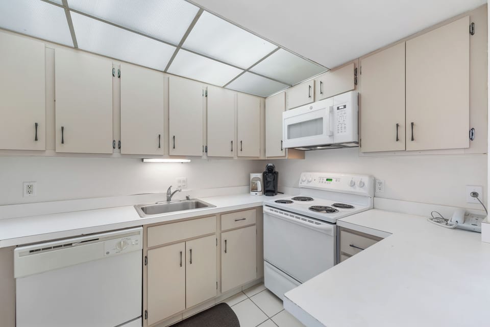 The beautiful, well stocked kitchen in beachy color tones.