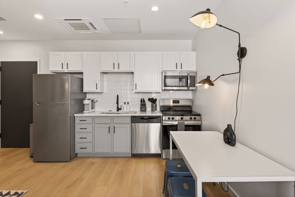 Fully stocked kitchen with stainless steel appliances, perfect for cooking in or grabbing takeout. 
