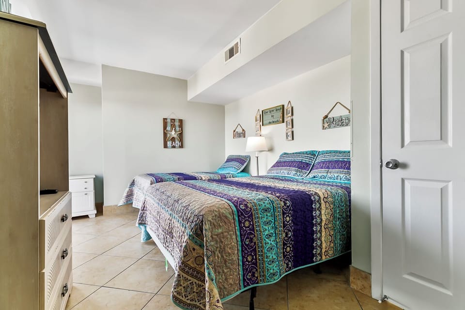 Spacious guest bedroom with queen bed and twin bed
