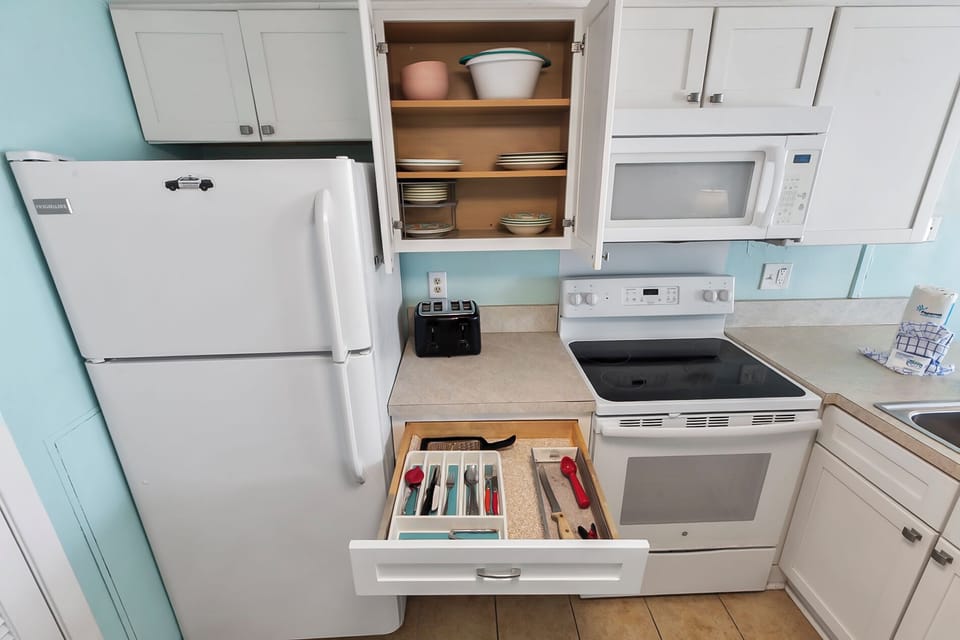 Fully-equipped kitchen with ample storage space and starter amenities