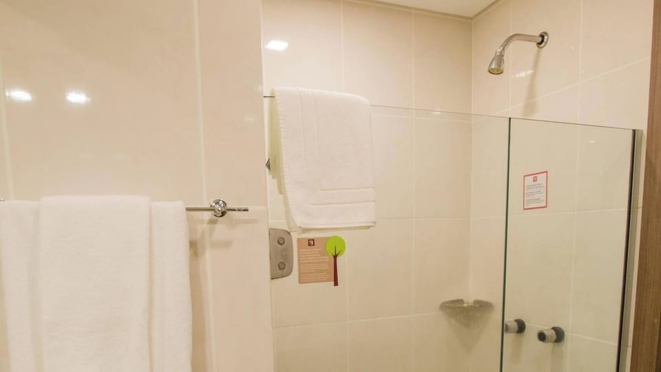 Rinse off under a clean, simple shower with glass screen.