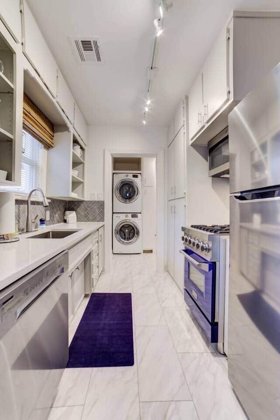 Moving from the dining room, the galley kitchen sits just off of the mudroom (which is how we enter and exit...the home). 

We have stocked the kitchen with the basics and hope you will feel right at home should you choose to cook.