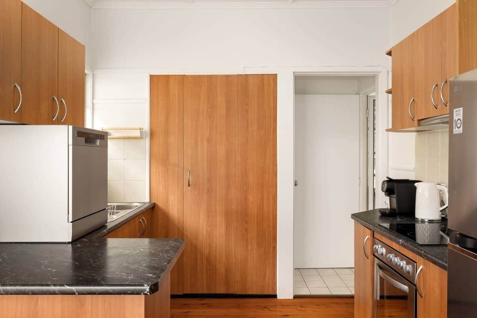Kitchen: Sleek kitchen with ample storage, modern appliances