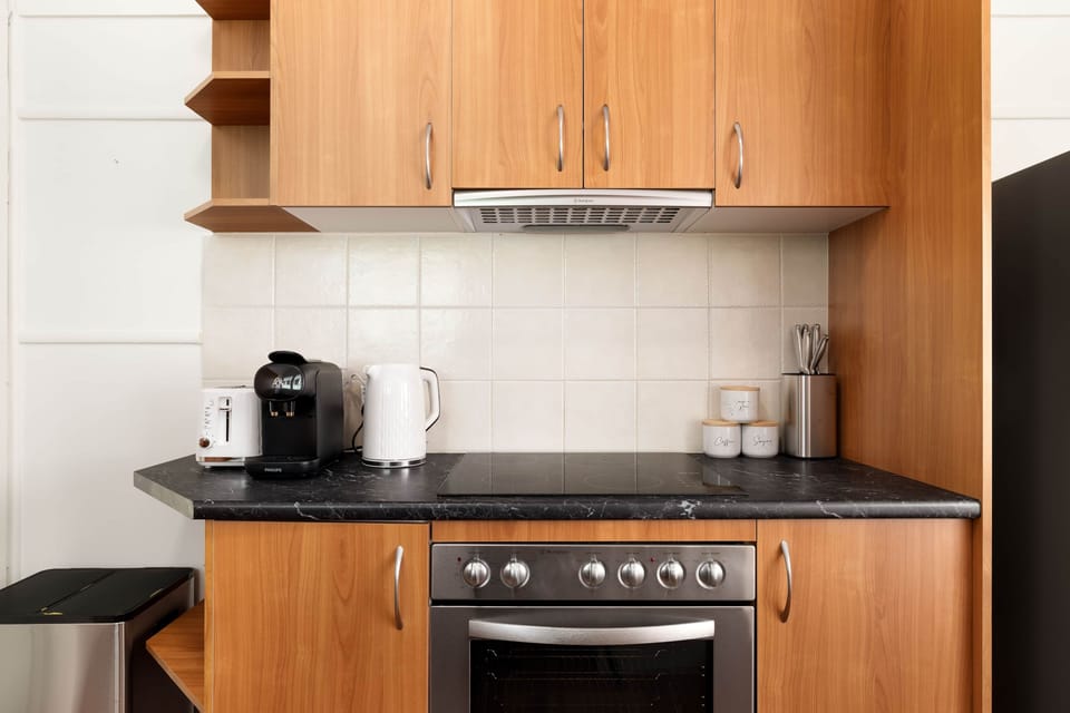 Kitchen: Sleek kitchen with ample storage, modern appliances