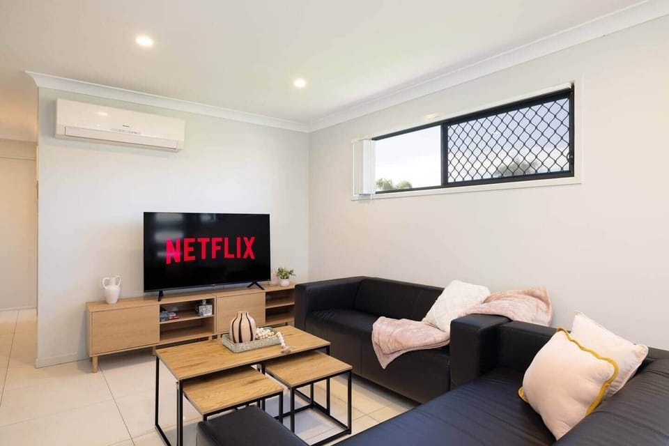 Living Area: Bright living space with comfortable seating and TV 