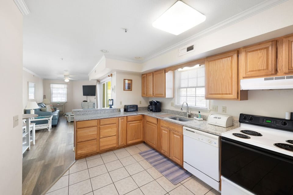 Fully equipped kitchen with dishwasher, microwave, and cookware.