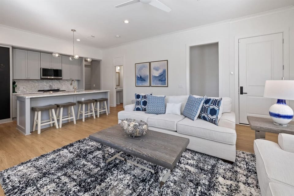 Open-concept living space filled with natural light and soft coastal hues.