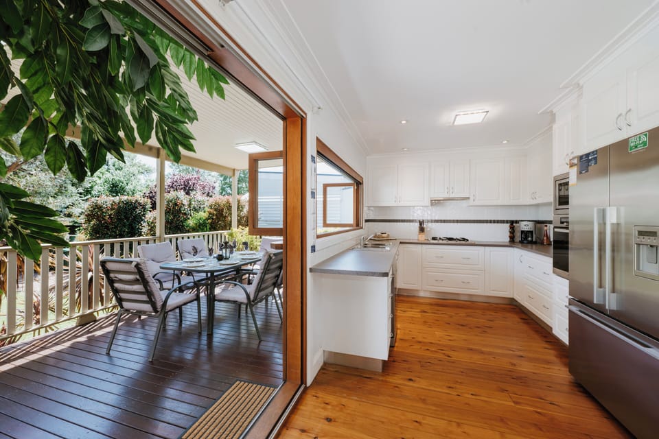 Enjoy seamless indoor-outdoor living with direct access from the modern kitchen to the deck for alfresco dining.