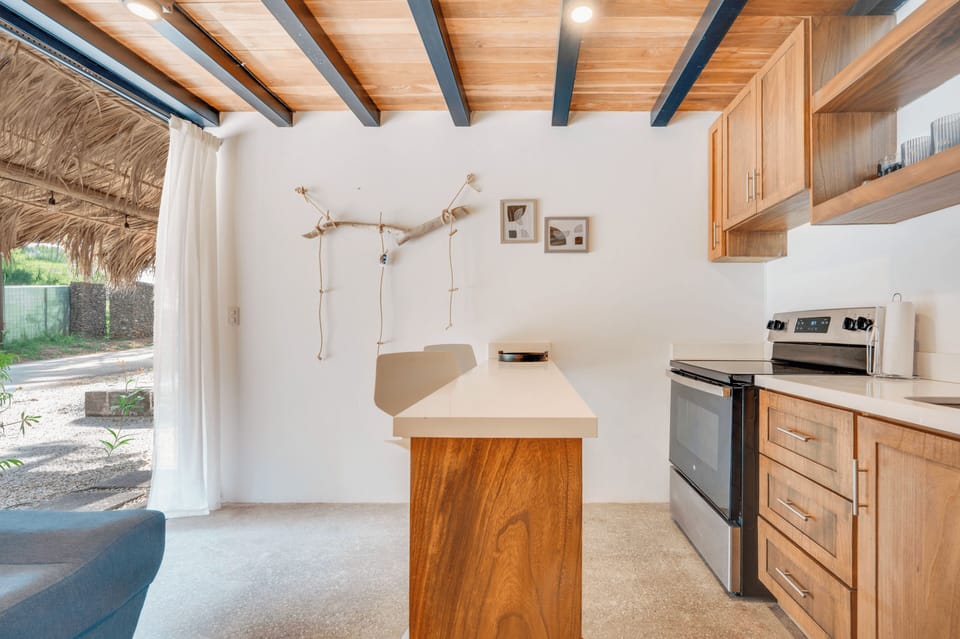 Full kitchen — stainless appliances, wood cabinets, all essentials