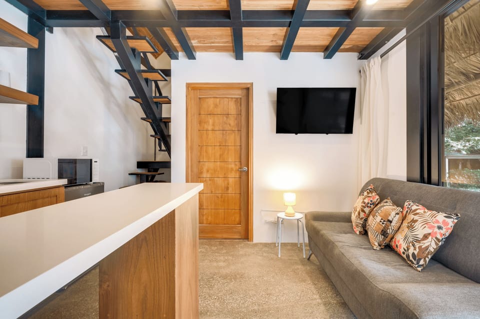 Living area with Smart TV — warm lighting, wood finishes throughout