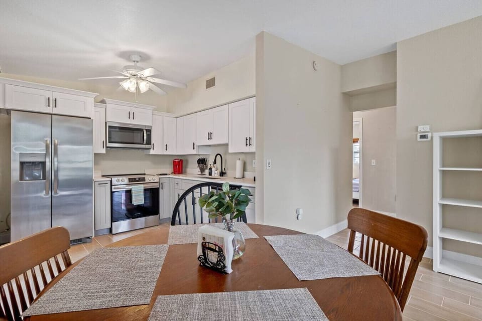 Dining table for up to 4 people with easy access and flow to the kitchen and screened in lanai.