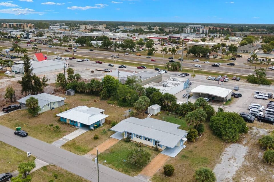 Aerial photo of the front entrance of the entire duplex showing the peaceful neighborhood.  Located with a empty lot next door with amble parking for larger vehicles on a concrete slab, if required.   Electricity available via extension cord.