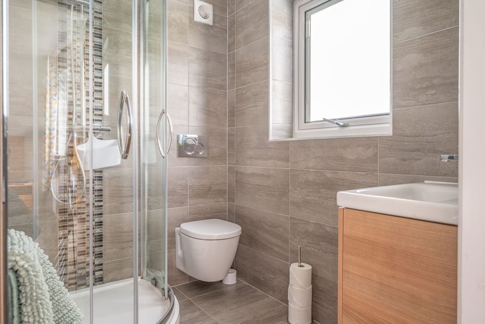 En suite shower room in bedroom 1 in Hedgehog's Cottage Coniston