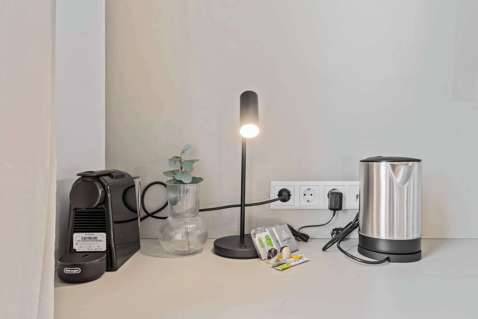  Desk space with a coffee maker and kettle for added convenience.