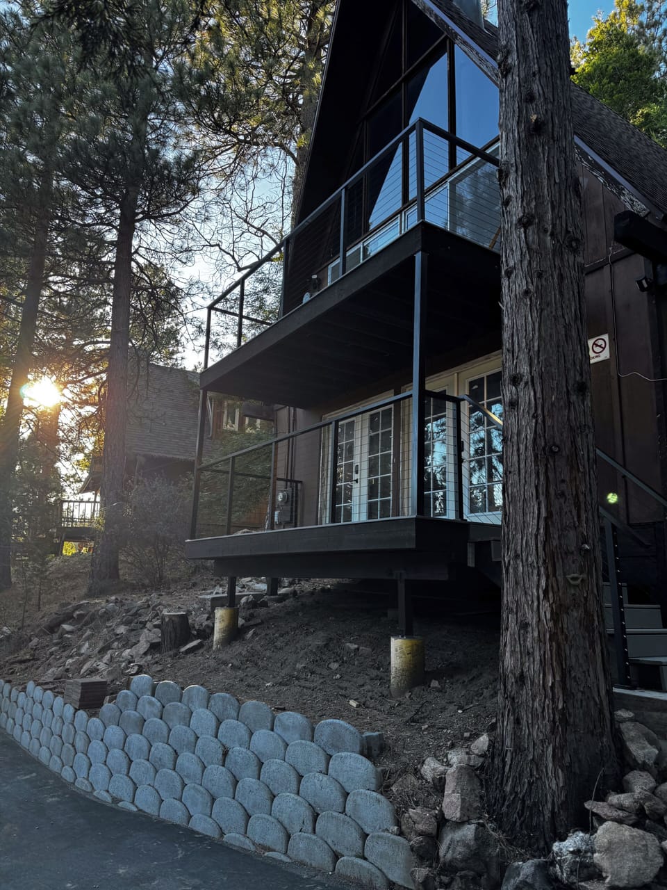 Updated exterior with new decks & balcony nestled among towering pines