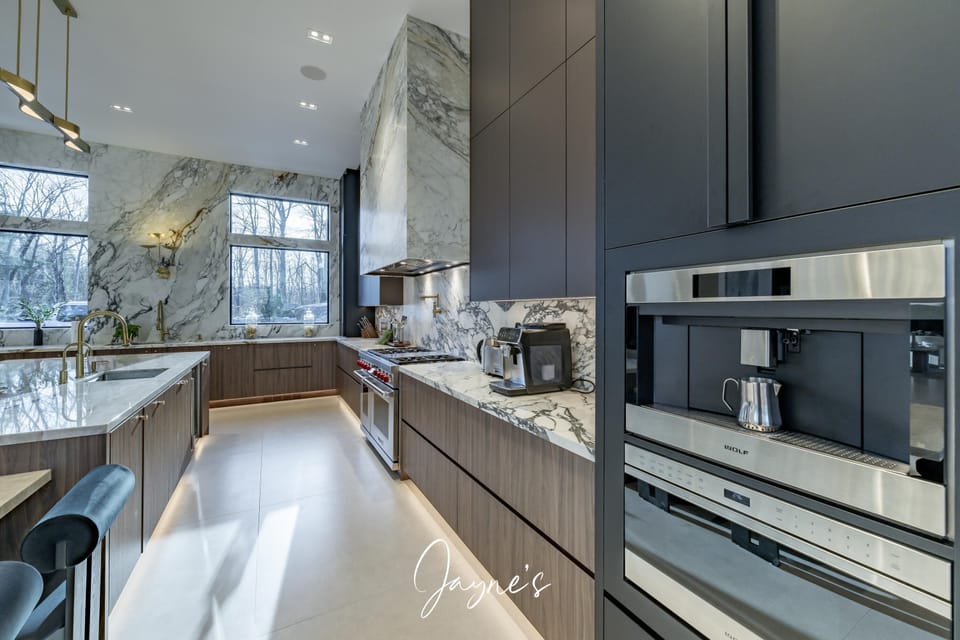 Sleek modern kitchen with marble accents and natural light