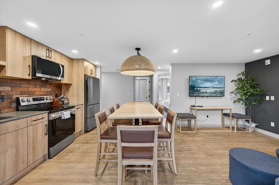 Featuring a modern kitchen with sleek appliances and charming brick accents, this stylish suite combines functionality with rustic elegance to enhance the culinary experience.