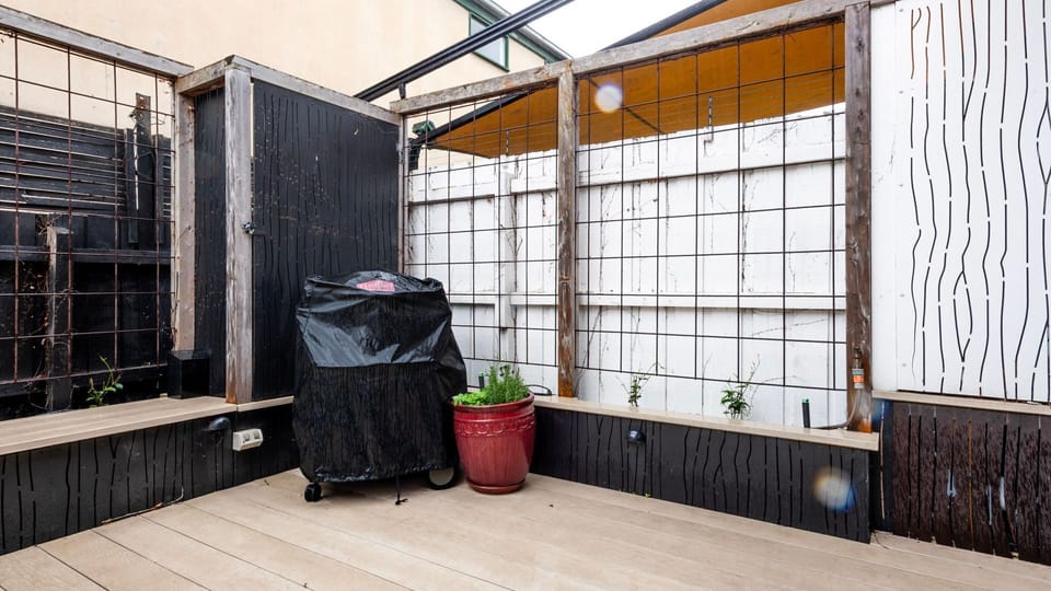 Cozy courtyard corner with BBQ and seating space.
