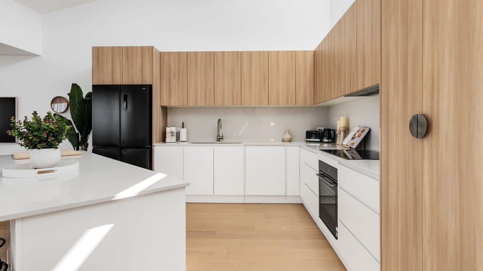 Stylish open kitchen with warm timber cabinetry