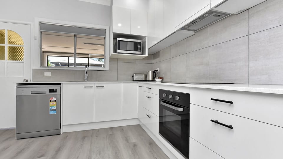 Alternate angle of the kitchen showing appliances and storage