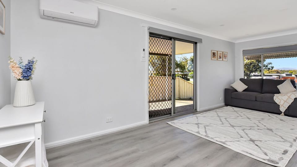 Bright lounge area with sliding door access to the side carport