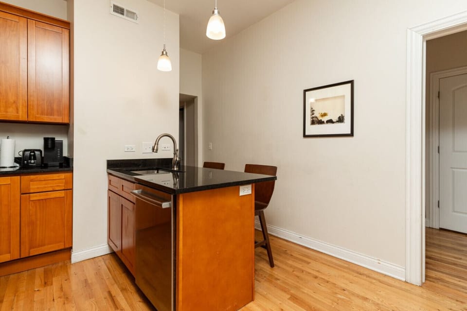 Channel your inner chef in this fully equipped kitchen, featuring stainless steel appliances, bar seating, and a dining table
