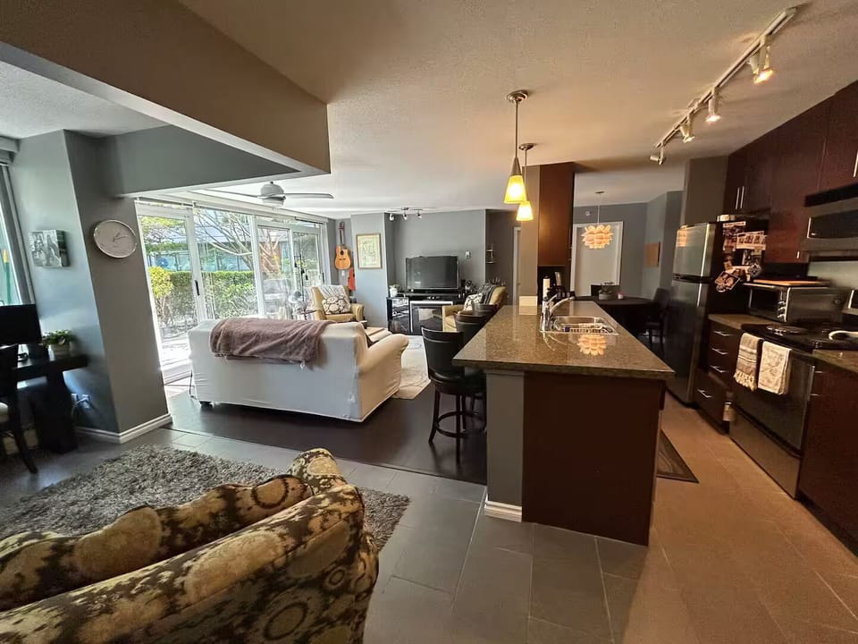 Lots of floor space, open concept kitchen with bar style island and ample counte