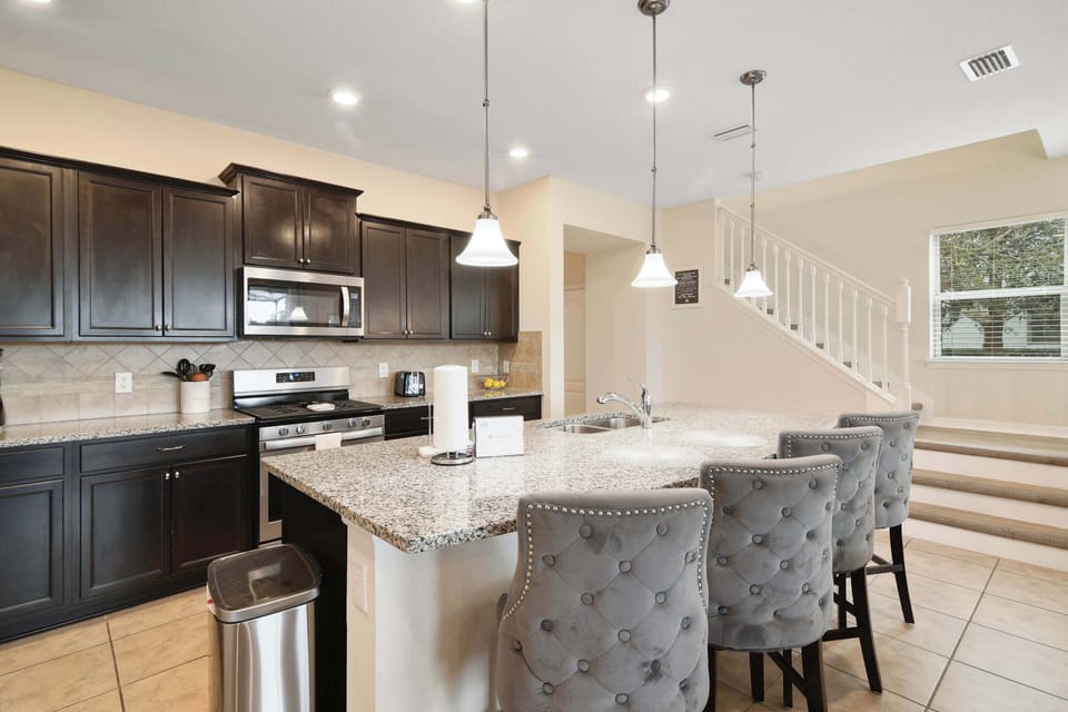 Modern kitchen with granite countertops and seating at the island