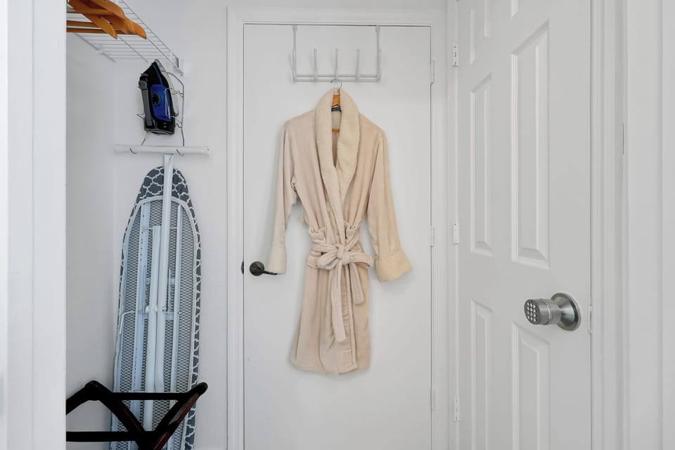 Robe, iron and board located in primary bedroom