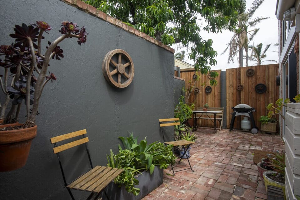 Breathe in the fresh air from your leafy brick courtyard, where mornings begin with birdsong and evenings end with wine under the trees.