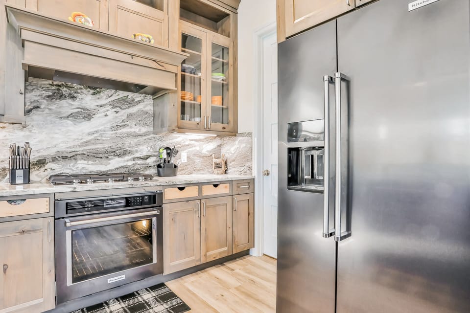 Modern appliances with a marble backsplash