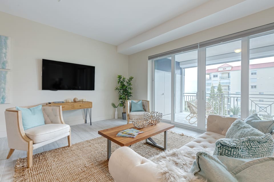Bright & airy living room with sliding glass doors that lead to outdoor balcony