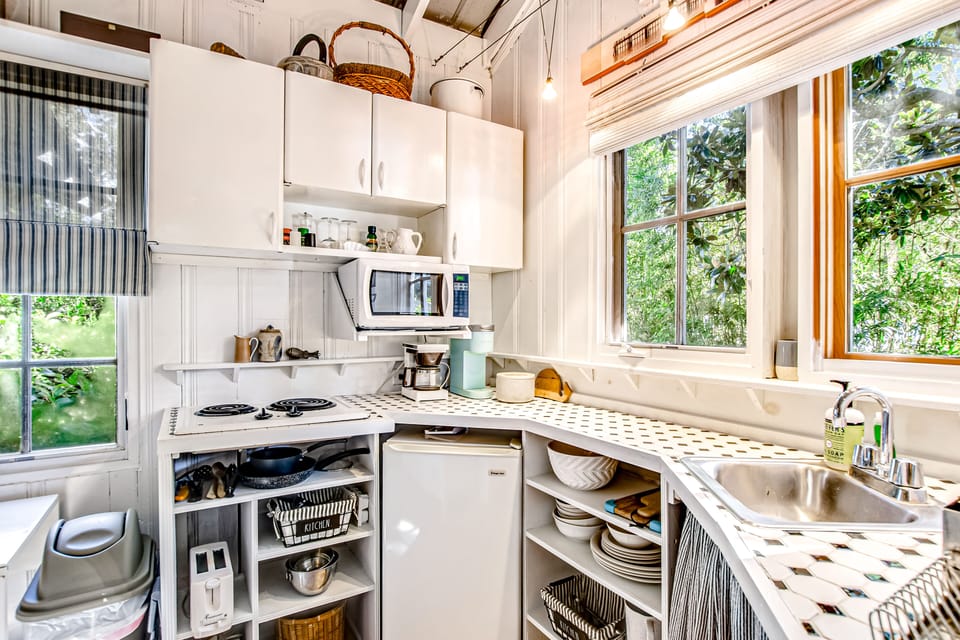 Kitchenette with mini fridge & small freezer in fridge, toaster, microwave and small burners.