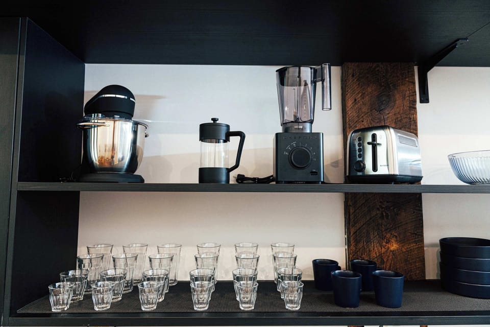 Modern, powerful appliances tucked neatly onto the shelving, blending utility and design.