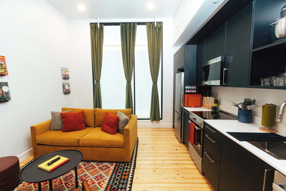 Bright, open layout connects cooking, dining, and conversation with ample natural light from the windows.